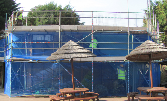 Scaffolding and protective netting installed